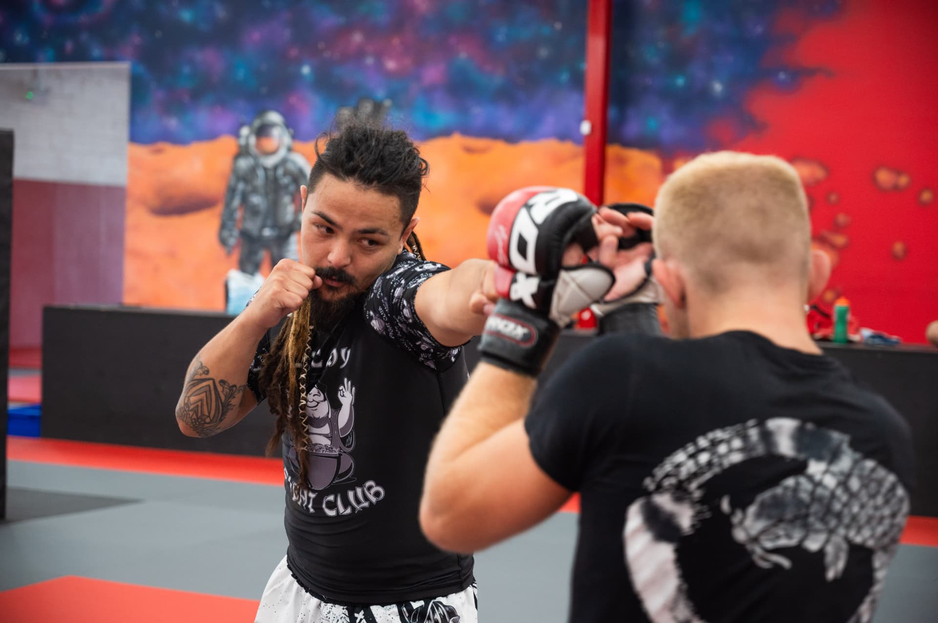 Matt working closely with a student on pads