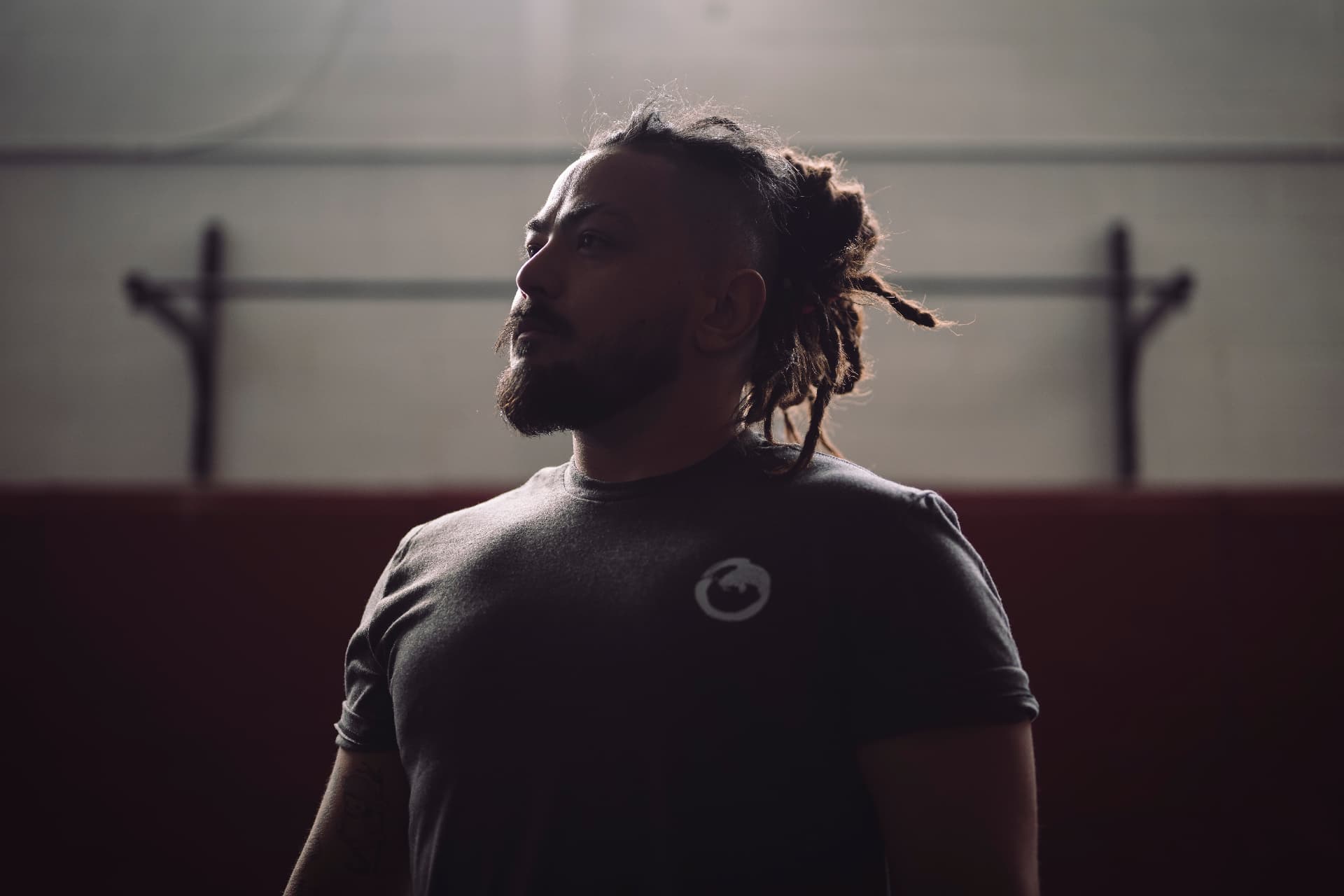 Matt in the gym under low, dramatic light
